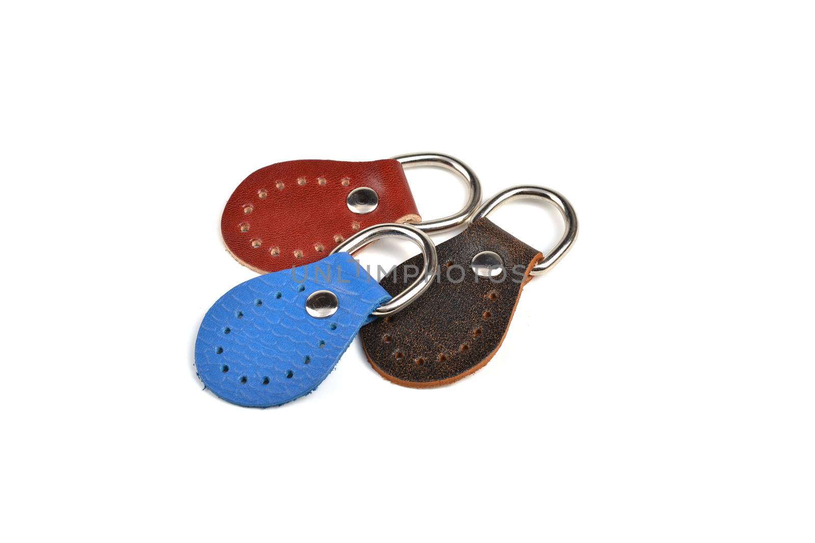 Blank blue brown red round color leather key chain collection on isolated white background with clipping path. Pile set of metallic souvenir.
