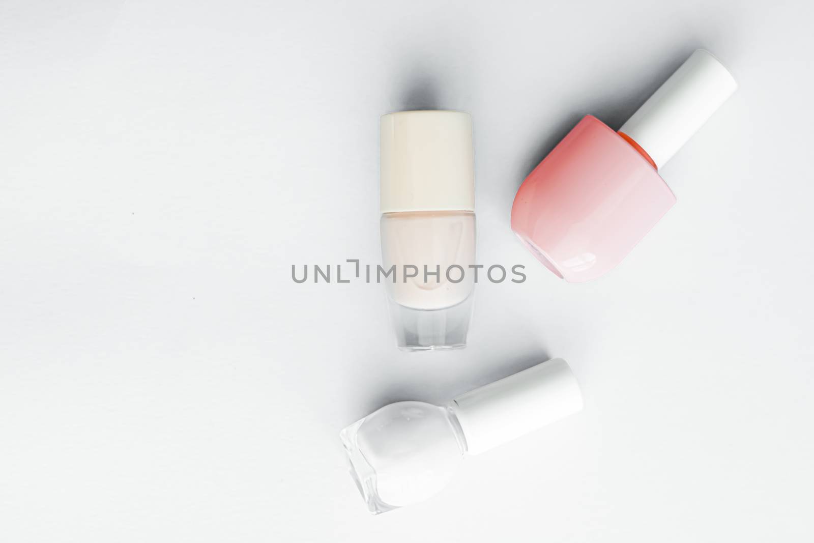 Nail polish bottles on white background, beauty branding