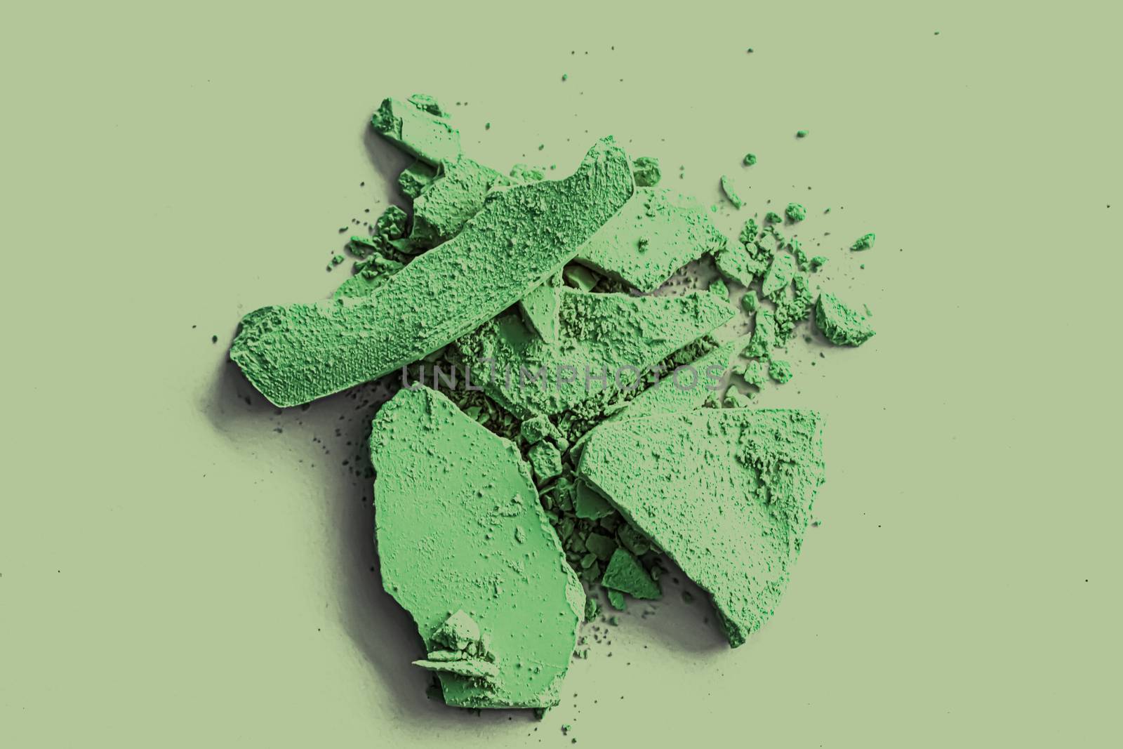 Green eye shadow powder as makeup palette closeup, crushed cosme by Anneleven