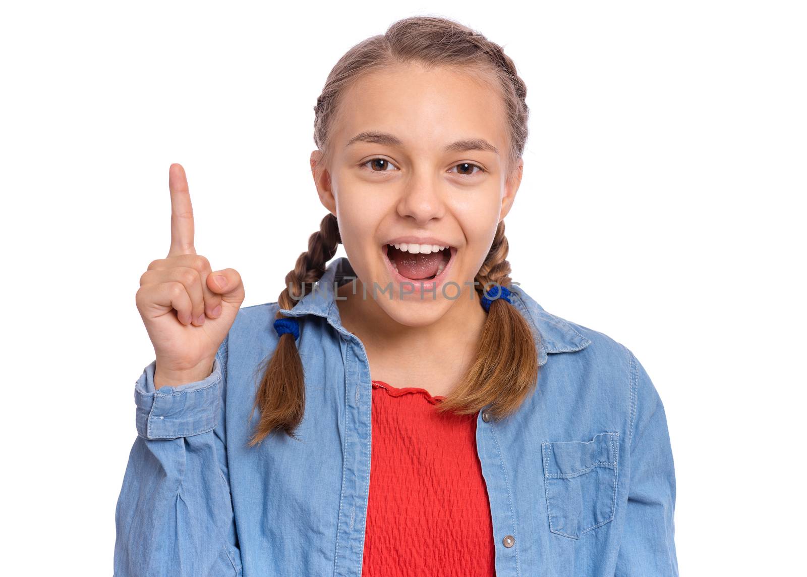 Happy teenage girl pointing up, gesturing idea or doing number one gesture, isolated on white background