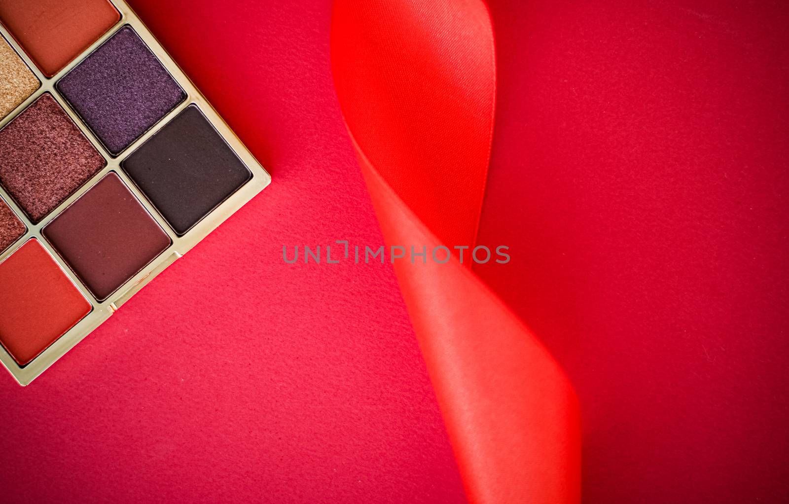 Eyeshadow palette and make-up brush on red background, eye shado by Anneleven