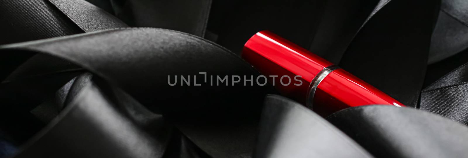Red lipstick on black silk background, luxury make-up and beauty by Anneleven