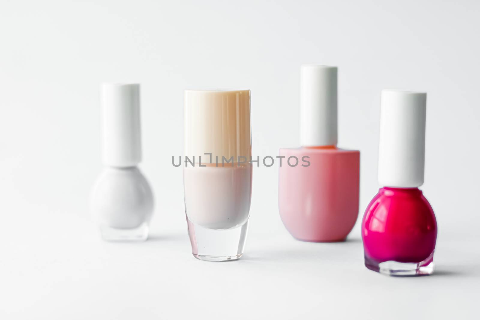 Nail polish bottles on white background, beauty branding