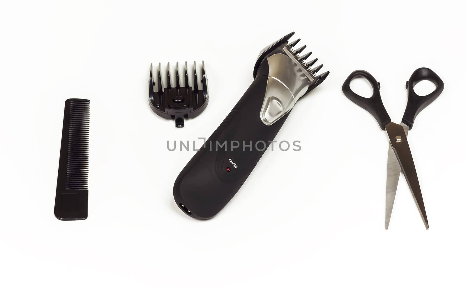 Hair clipper with nozzle, scissors and comb on white background