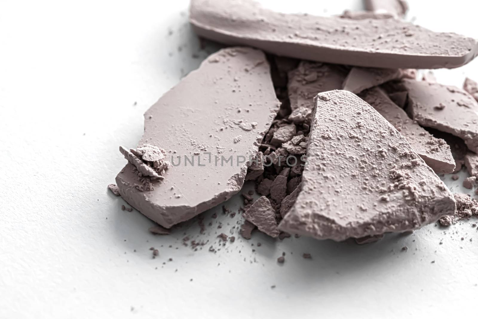 Pale eye shadow powder as makeup palette closeup isolated on white background, crushed cosmetics and beauty textures