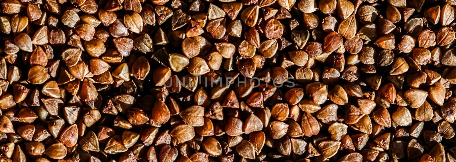 Buckwheat grain closeup, food texture and cook book background by Anneleven