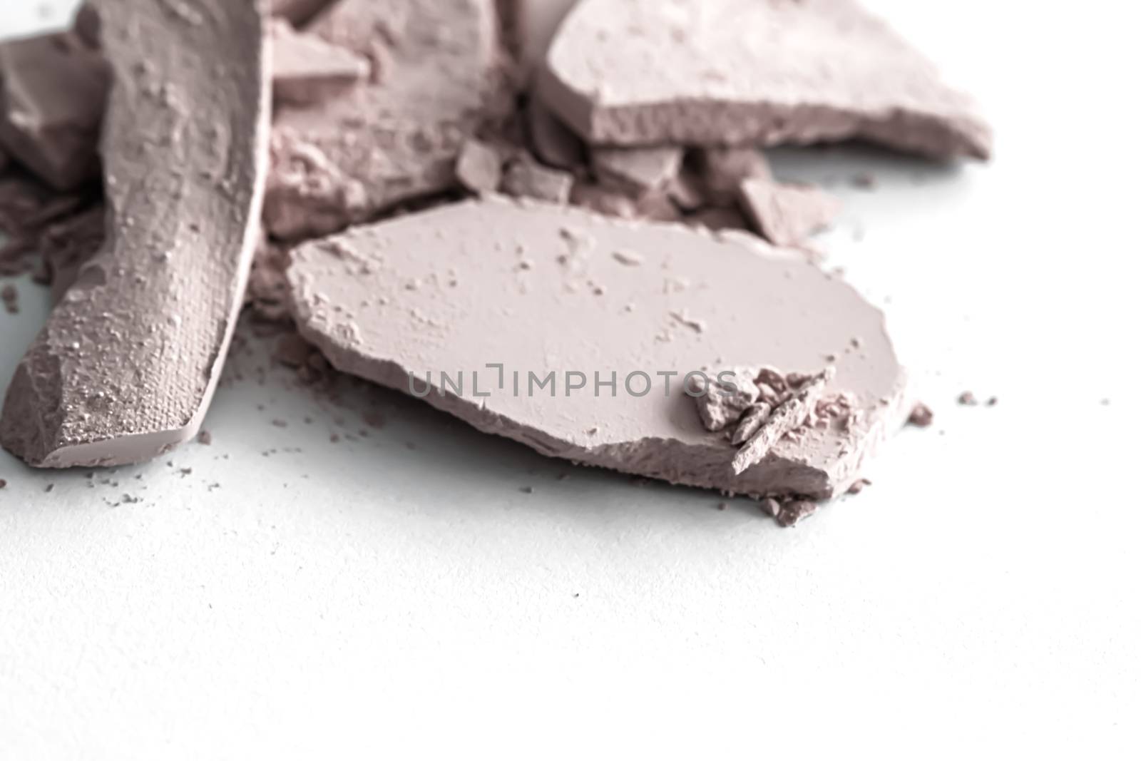 Pale eye shadow powder as makeup palette closeup isolated on white background, crushed cosmetics and beauty textures