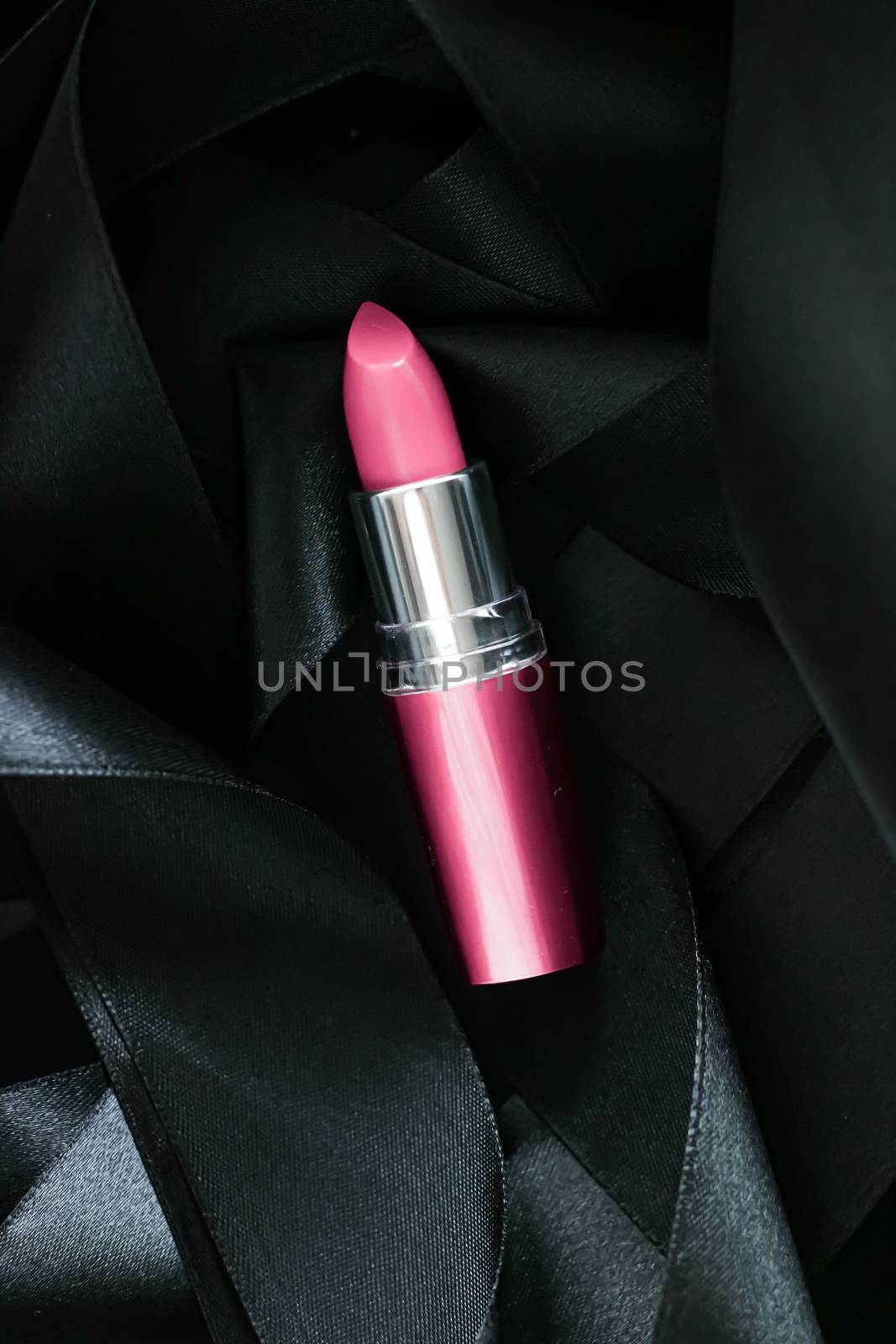 Pink lipstick on black silk background, luxury make-up and beauty cosmetics