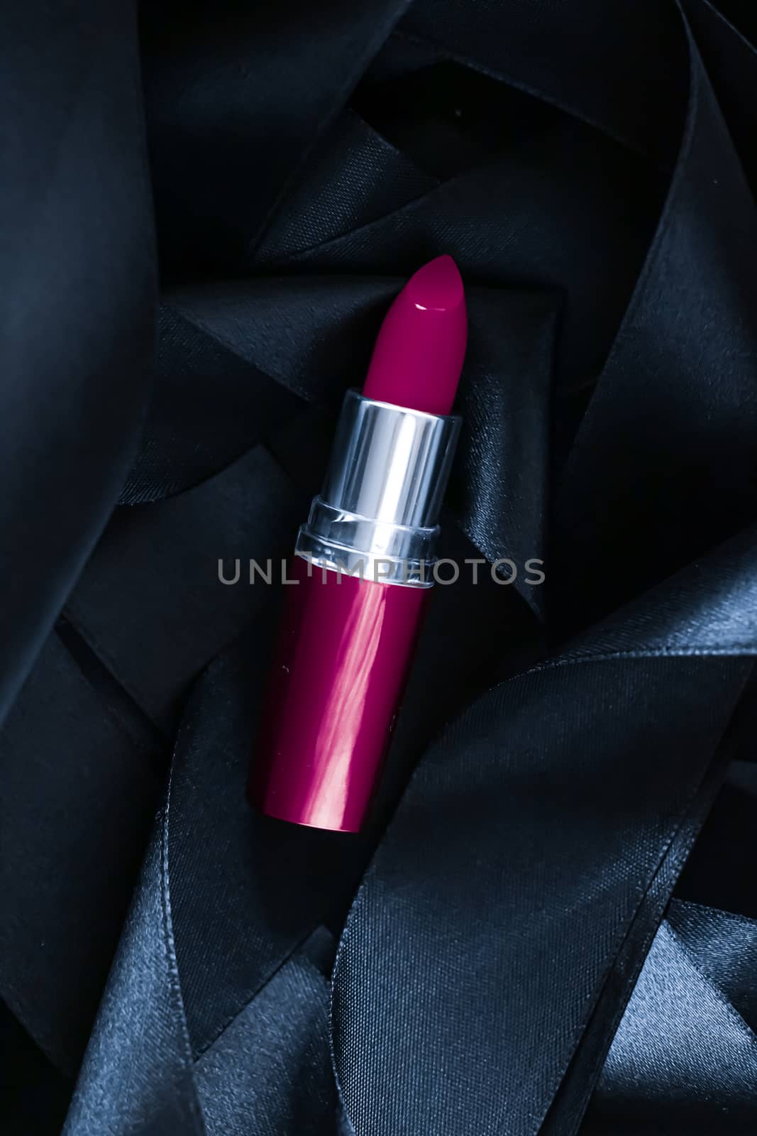 Purple lipstick on black silk background, luxury make-up and beauty cosmetics