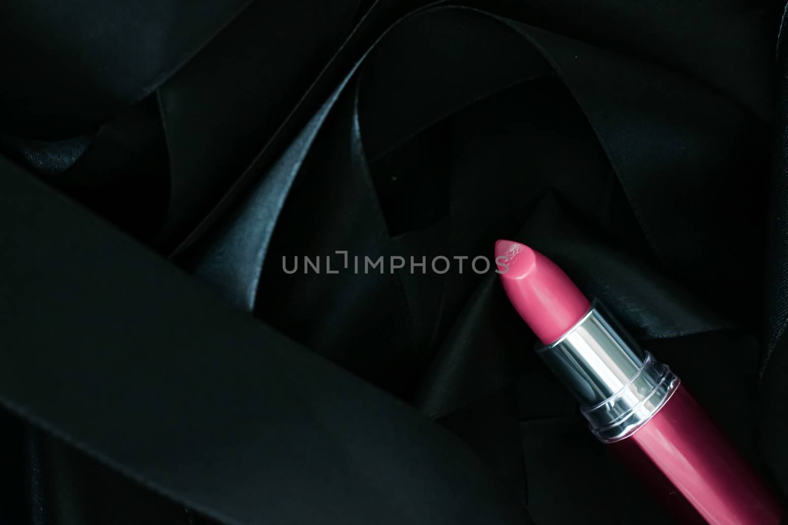 Pink lipstick on black silk background, luxury make-up and beauty cosmetics