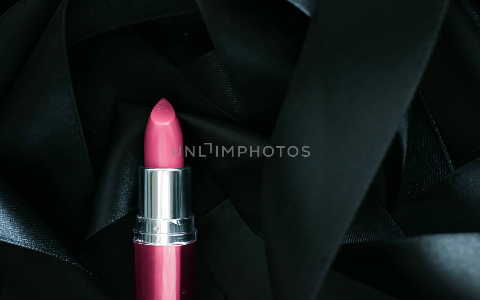 Pink lipstick on black silk background, luxury make-up and beauty cosmetics