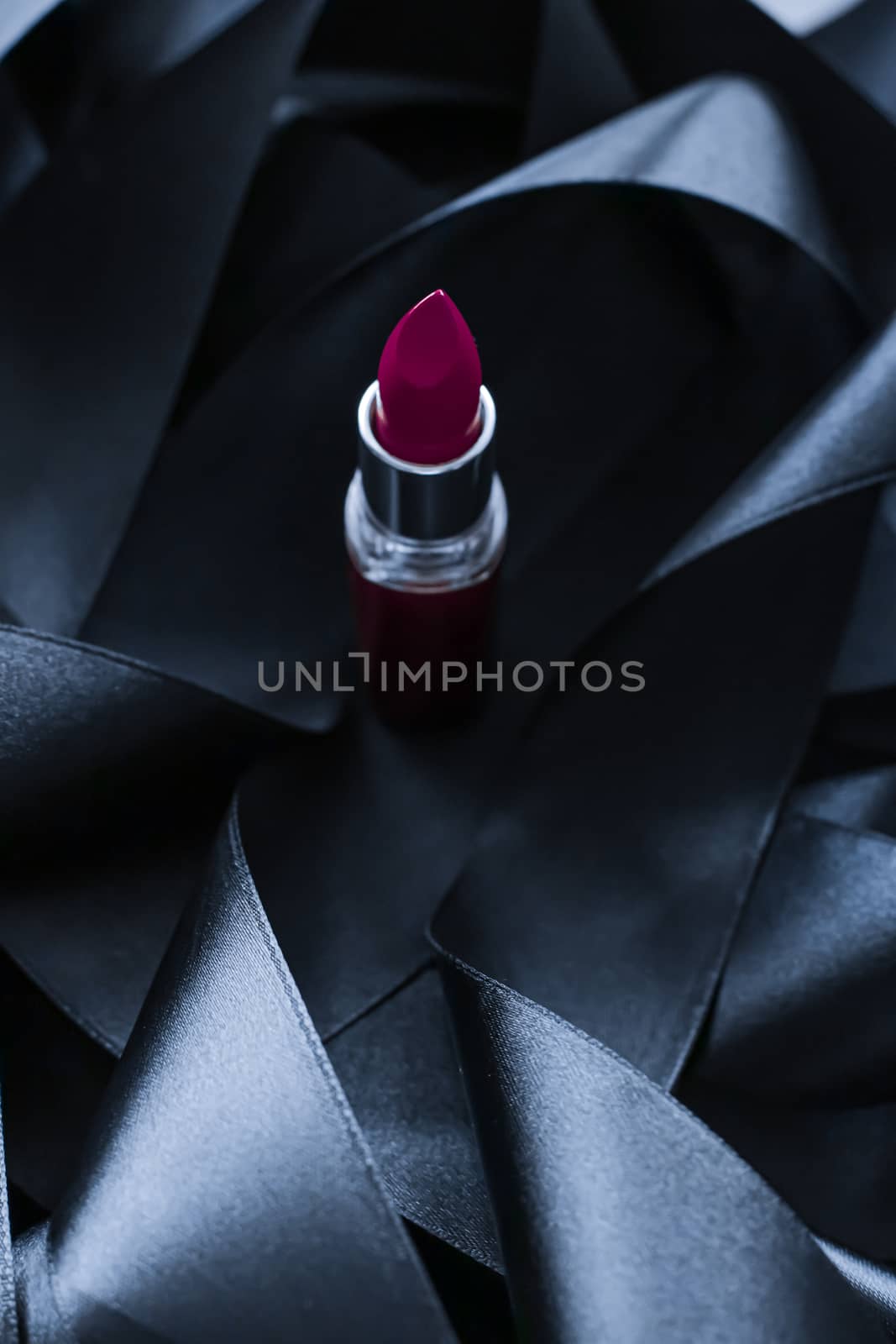 Purple lipstick on black silk background, luxury make-up and bea by Anneleven