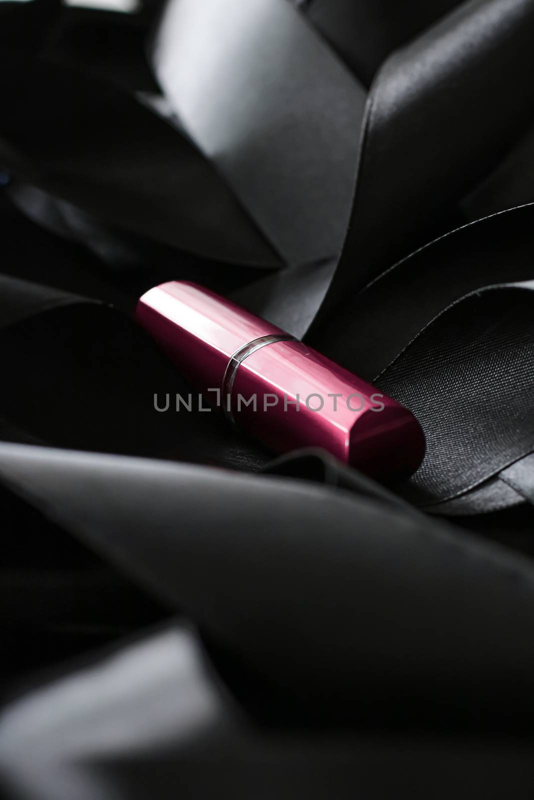 Pink lipstick on black silk background, luxury make-up and beauty cosmetics