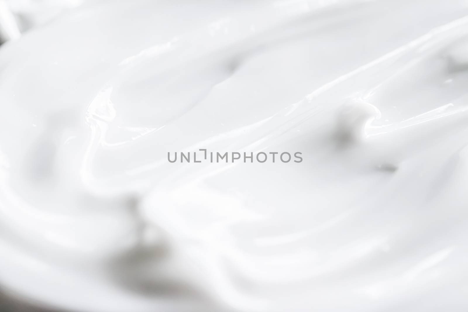 Pure white cream texture as abstract background, food substance or organic cosmetics