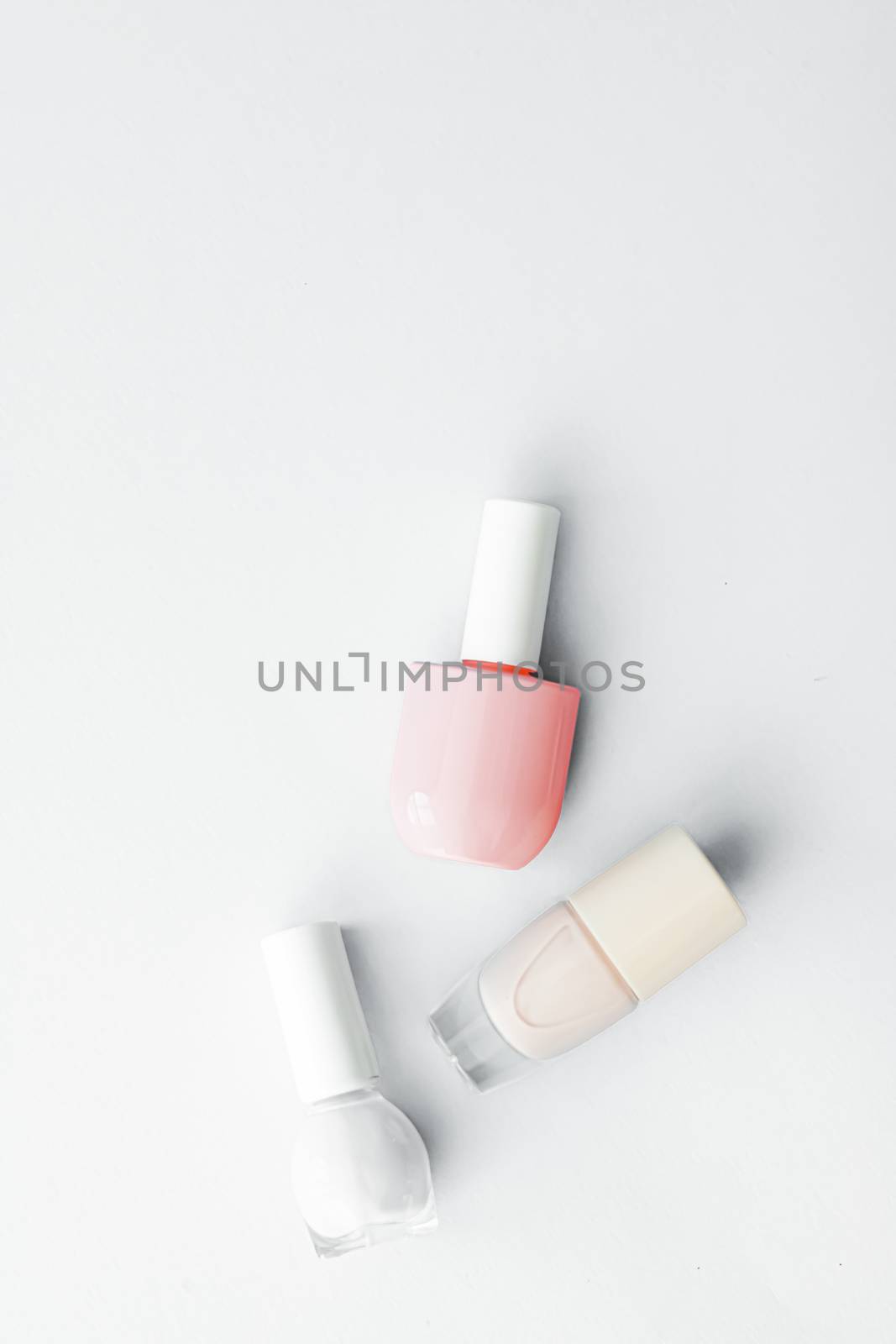 Nail polish bottles on white background, beauty branding