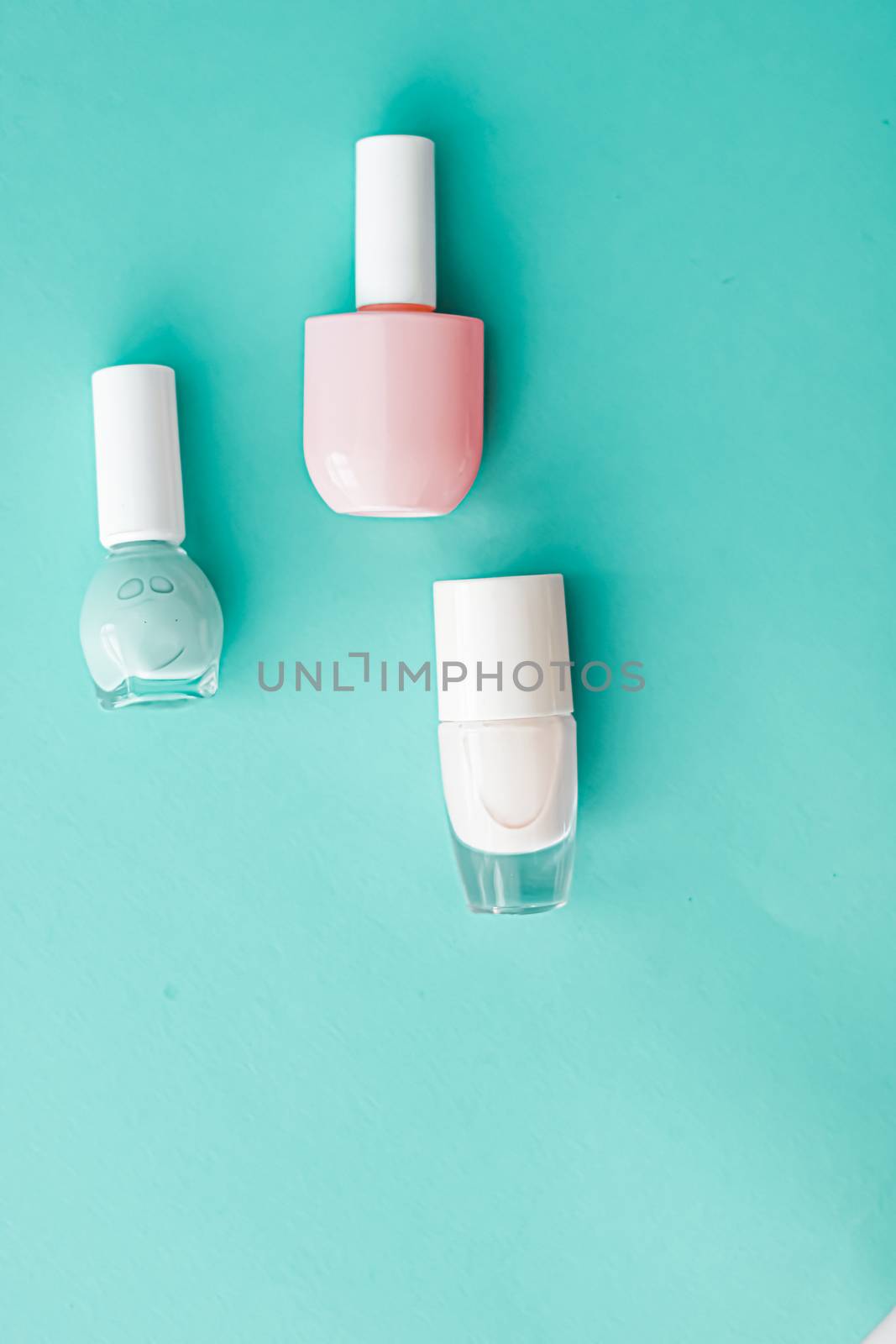 Nail polish bottles on green background, beauty brand by Anneleven