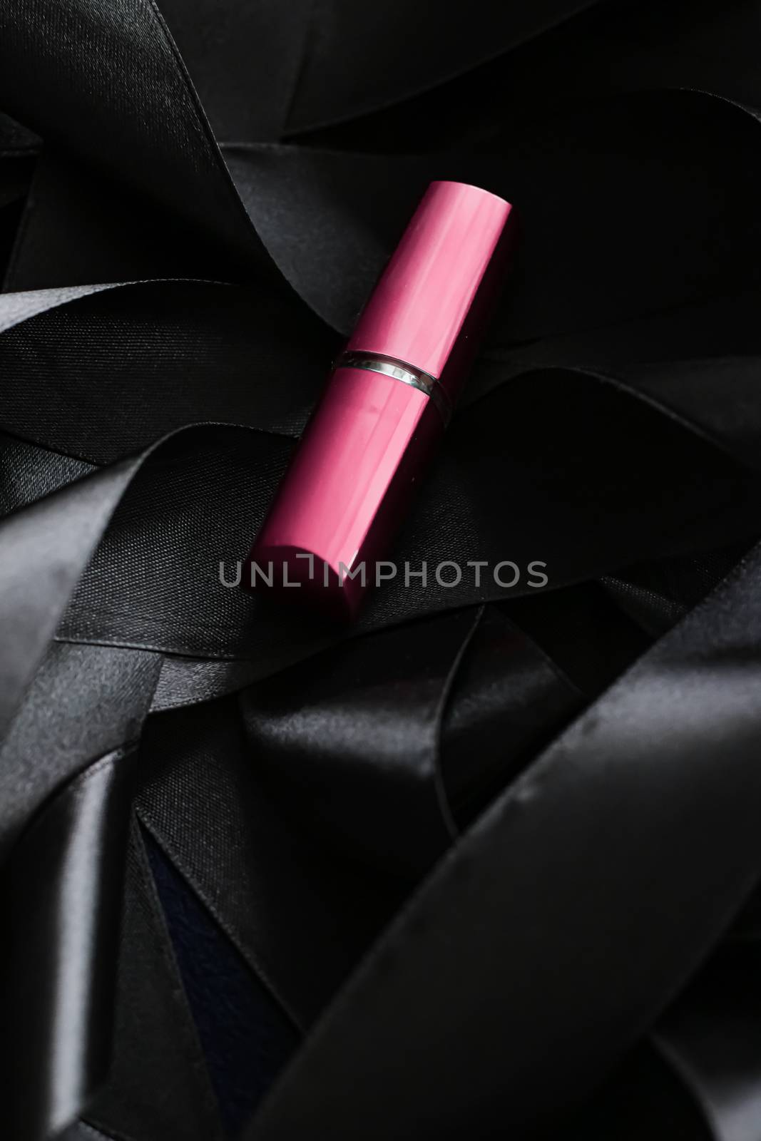 Pink lipstick on black silk background, luxury make-up and beauty cosmetics