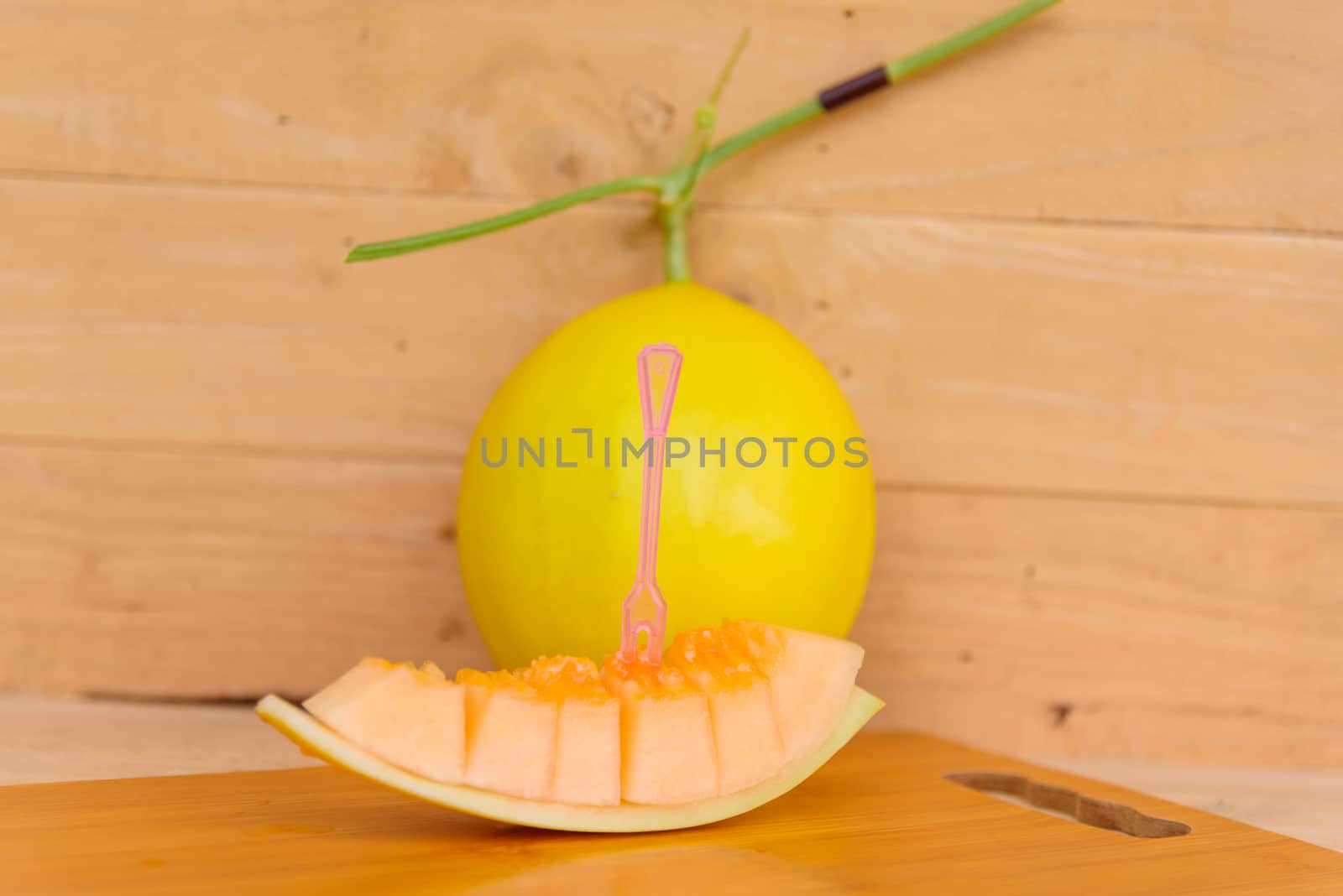 fresh golden melon on wood plate