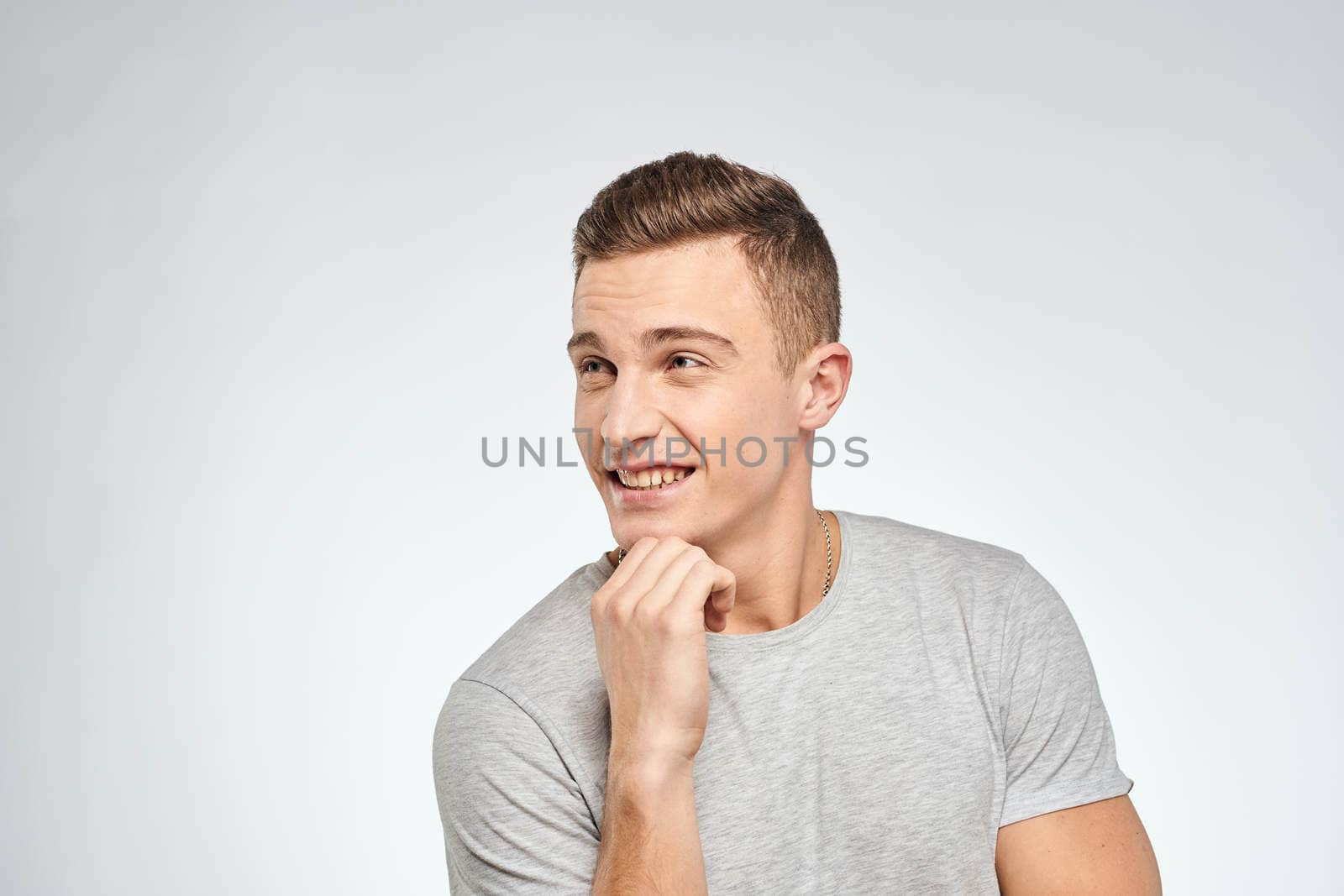 man in gray t-shirt emotions light background cropped view by SHOTPRIME