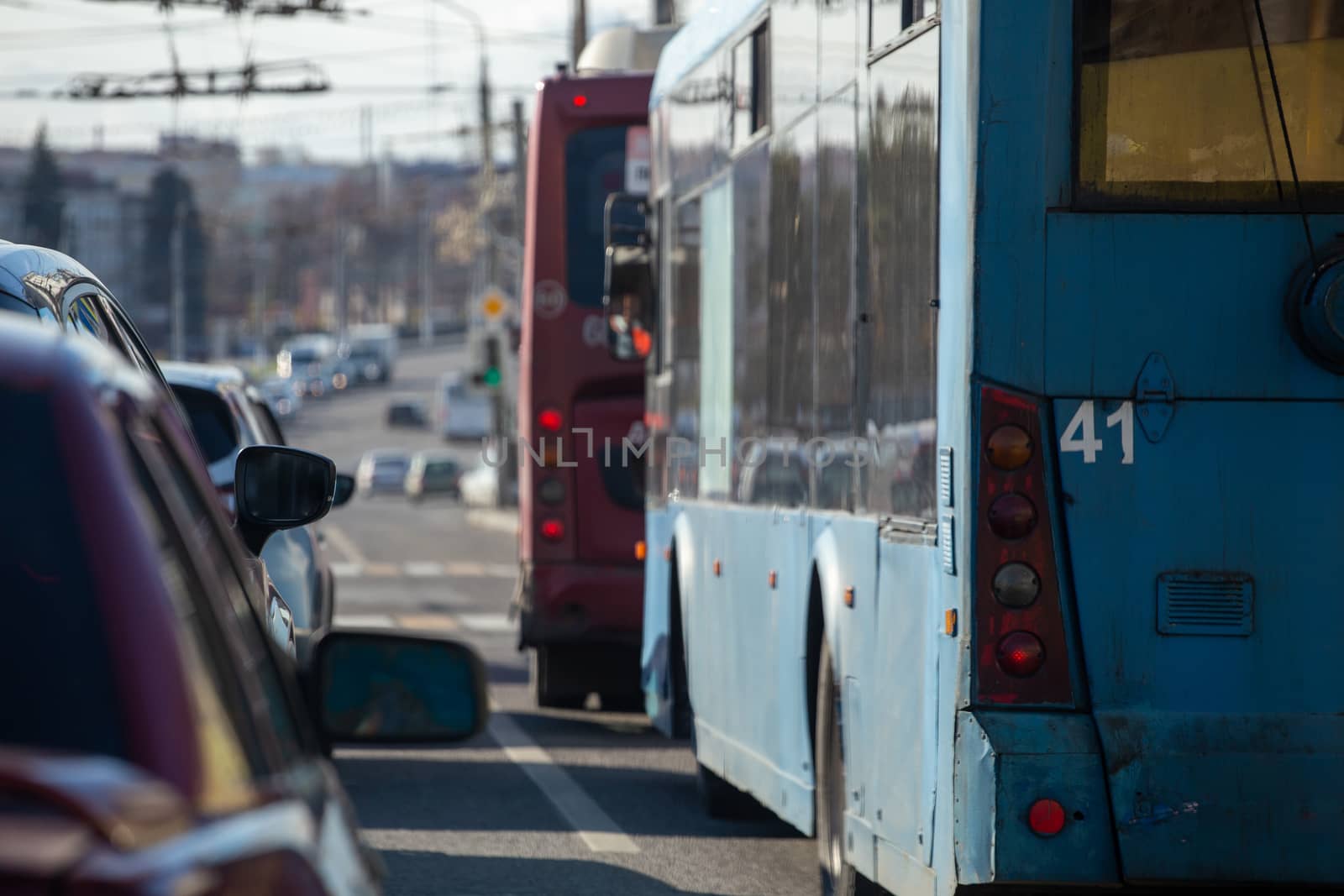 traffic jam in autumn russian city at daylight - selective focus view from inside.