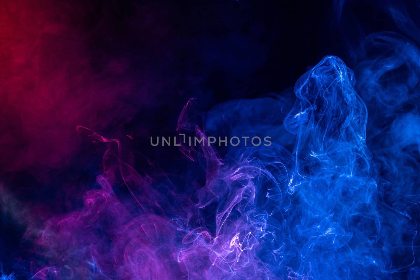 Conceptual image of colorful red and blue color smoke isolated on dark black background, Halloween concept design element.