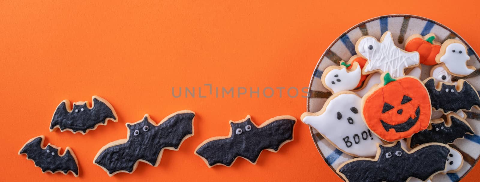 Top view of Halloween festive decorated icing sugar cookies on o by ROMIXIMAGE