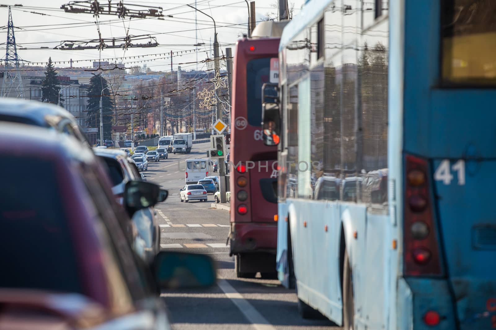 traffic jam in autumn russian city at daylight - selective focus view from inside.