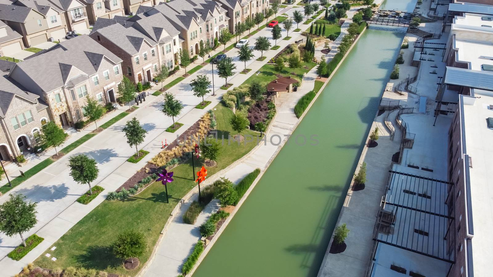 Aerial view riverside townhouses and mall strips along canal in Flower Mound, Texas, USA by trongnguyen