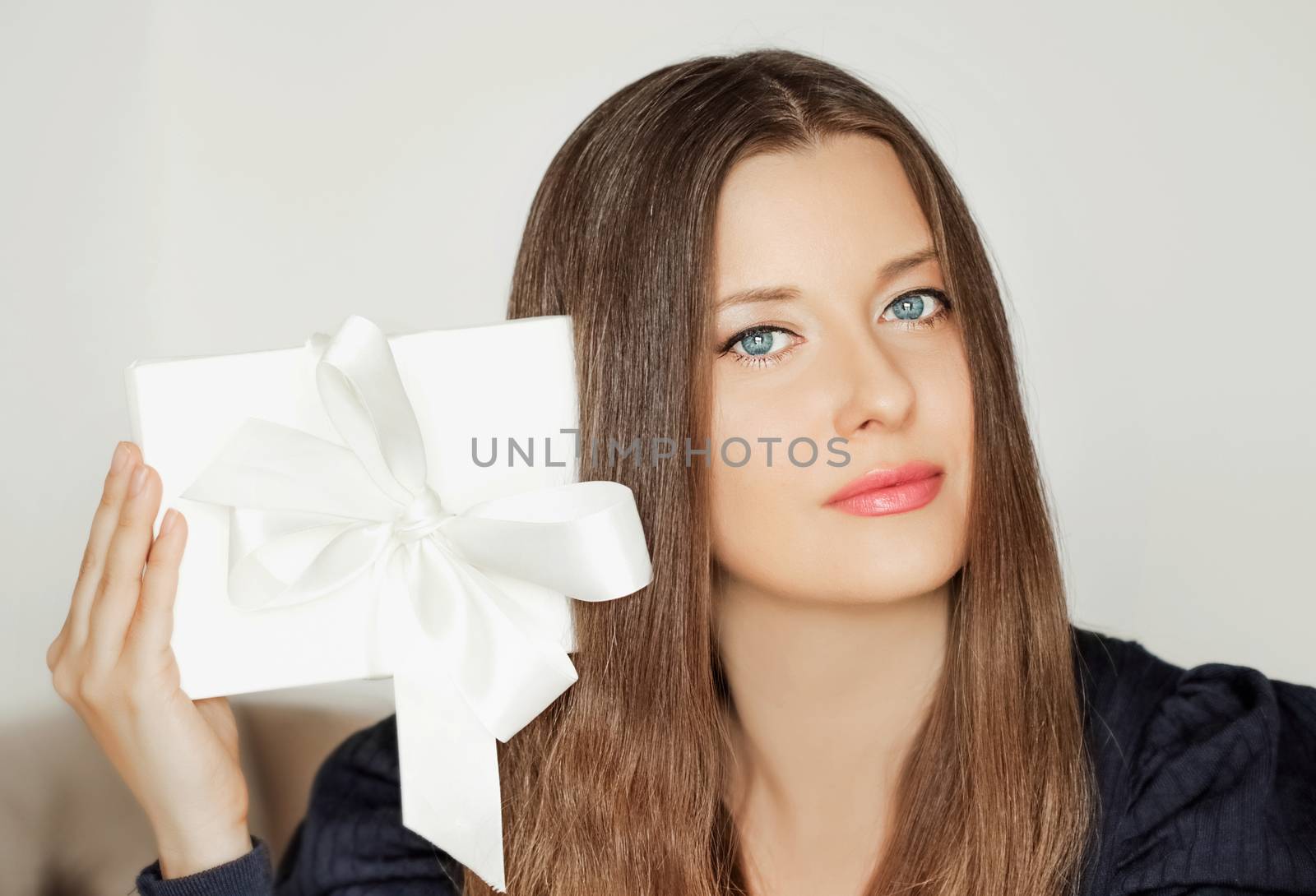 Beautiful woman holding white gift box, beauty portrait and luxu by Anneleven