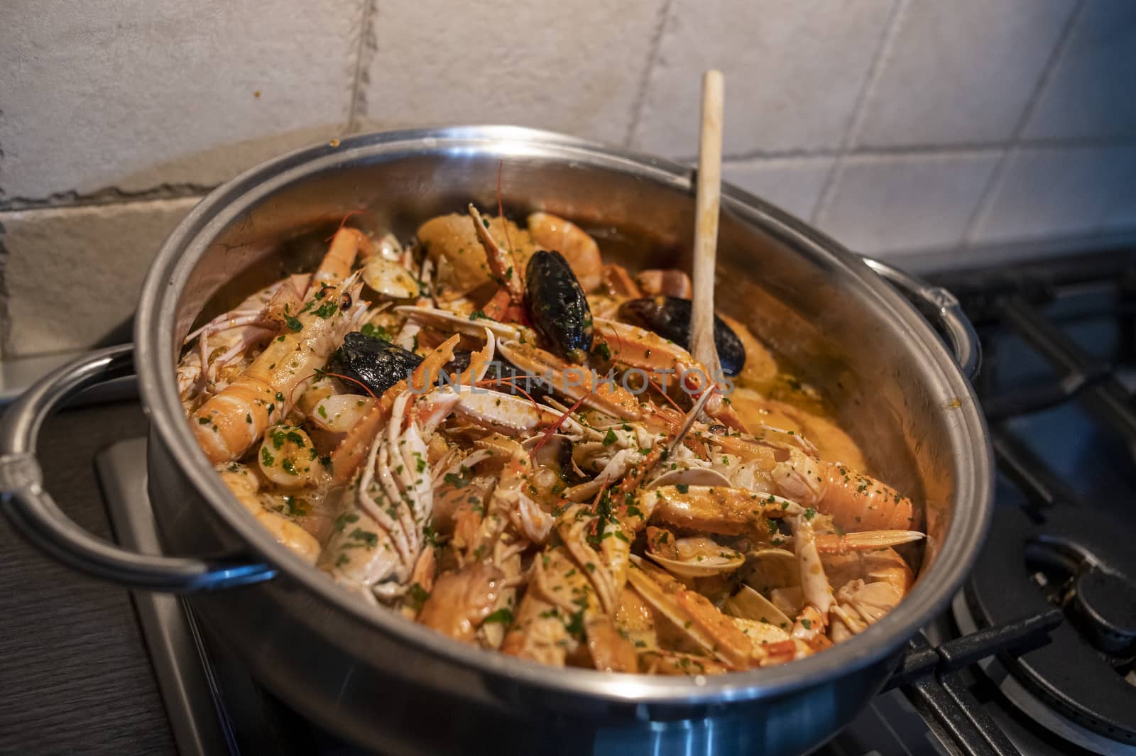 fresh fish soup with scampi and seafood with clams and mussels
