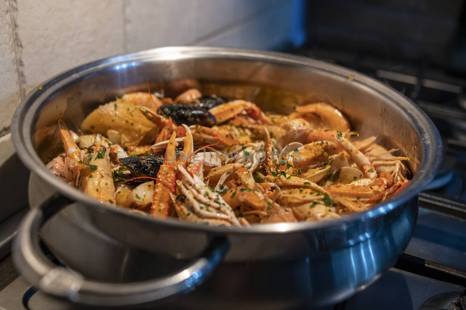 fresh fish soup with scampi and seafood with clams and mussels