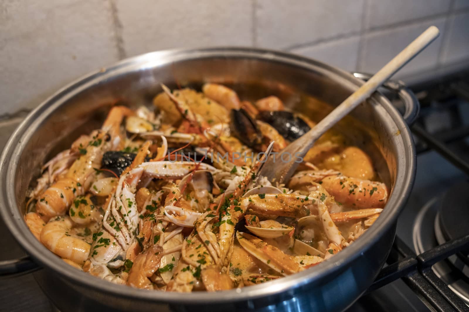 fresh fish soup with scampi and seafood with clams and mussels
