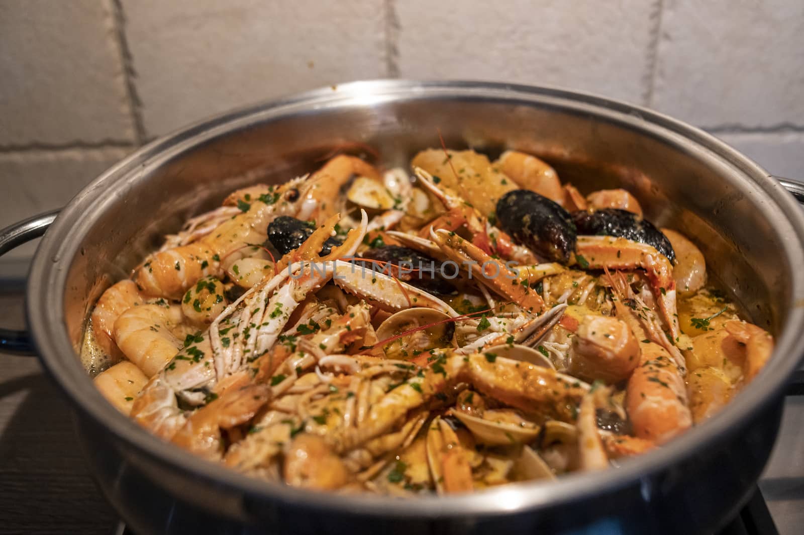 fresh fish soup with scampi and seafood with clams and mussels