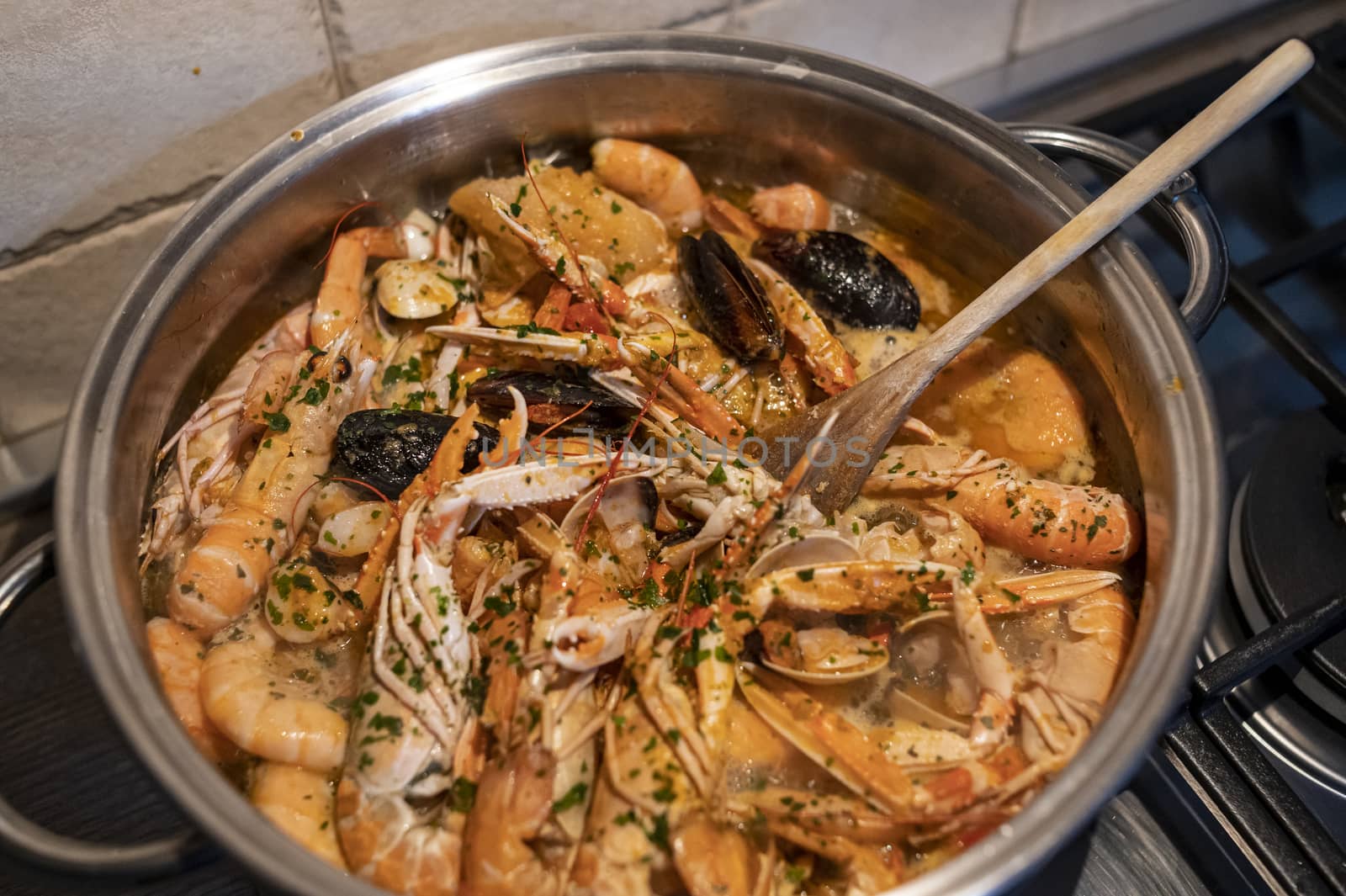 fresh fish soup with scampi and seafood with clams and mussels