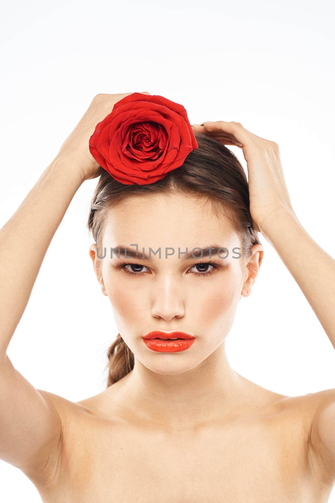 charming brunette girl with makeup on her face and a red rose in her hand. High quality photo