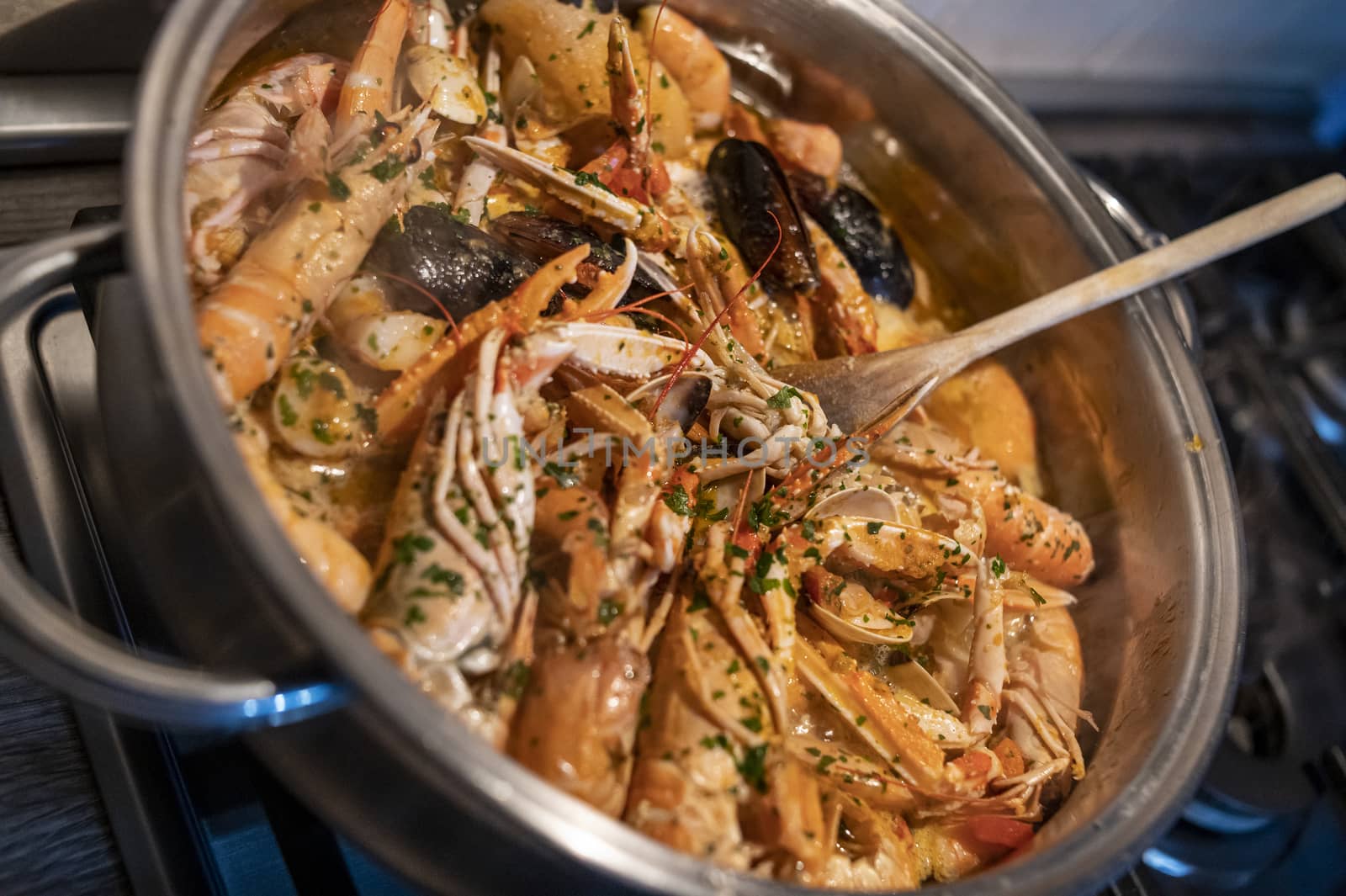 fresh fish soup with scampi and seafood with clams and mussels