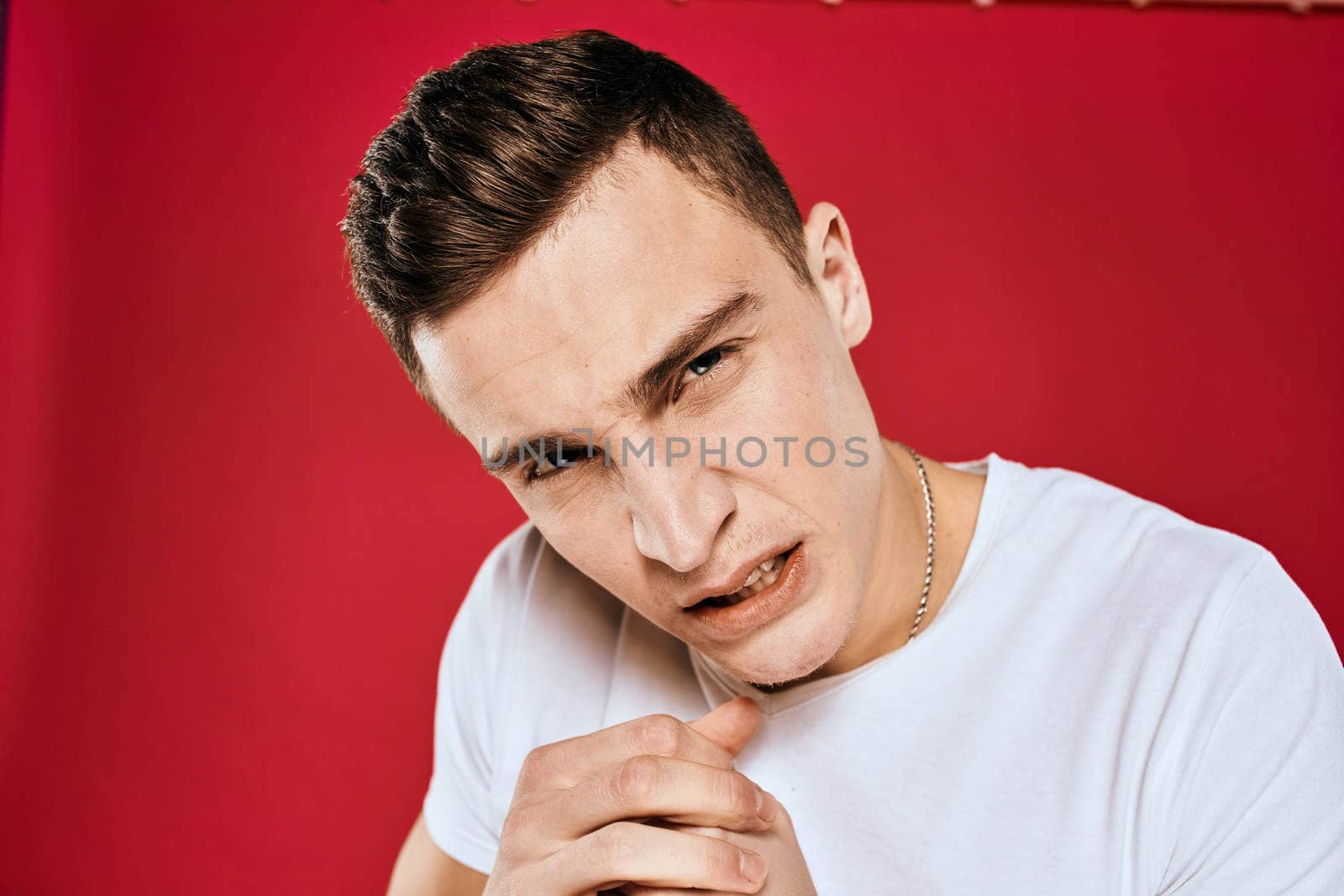 Man in white t-shirt emotions displeased facial expression isolated background by SHOTPRIME