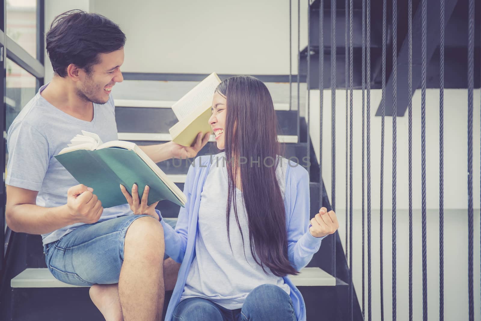 Couple asian handsome man and beautiful woman reading book and glad at home, boyfriend and girlfriend with activities together for leisure, education success concept.
