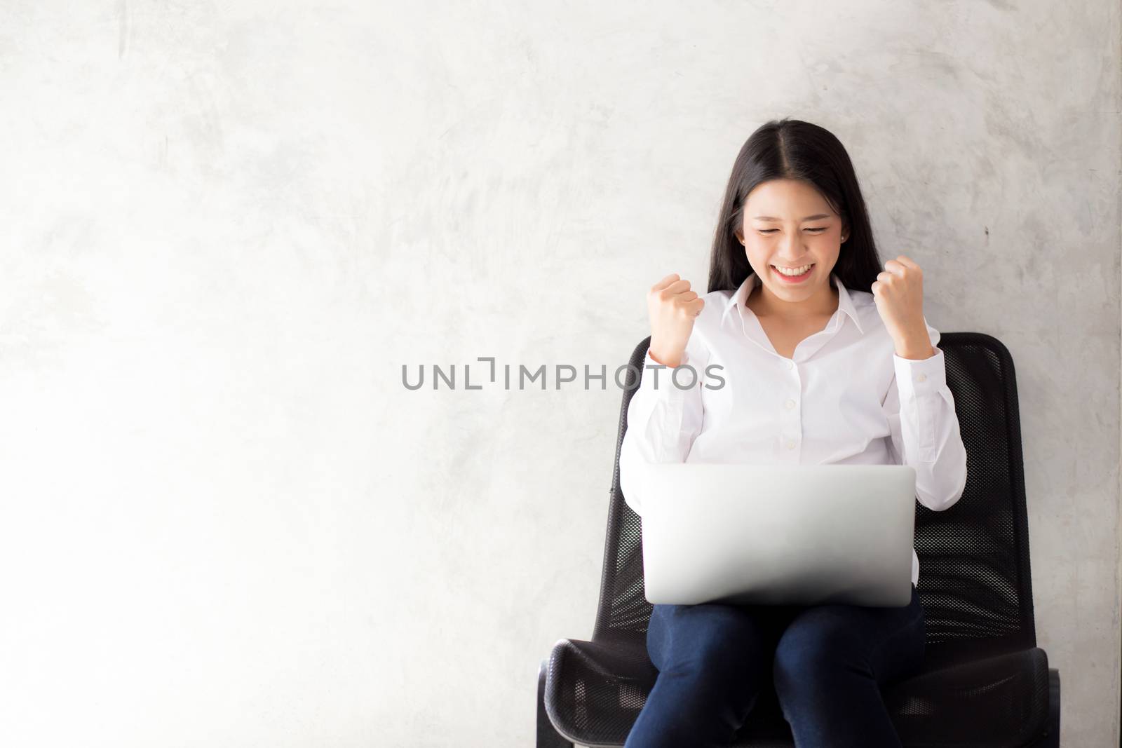 Beautiful asian young woman excited and glad of success with laptop, girl working coffee shop on cement background, career freelance business concept.