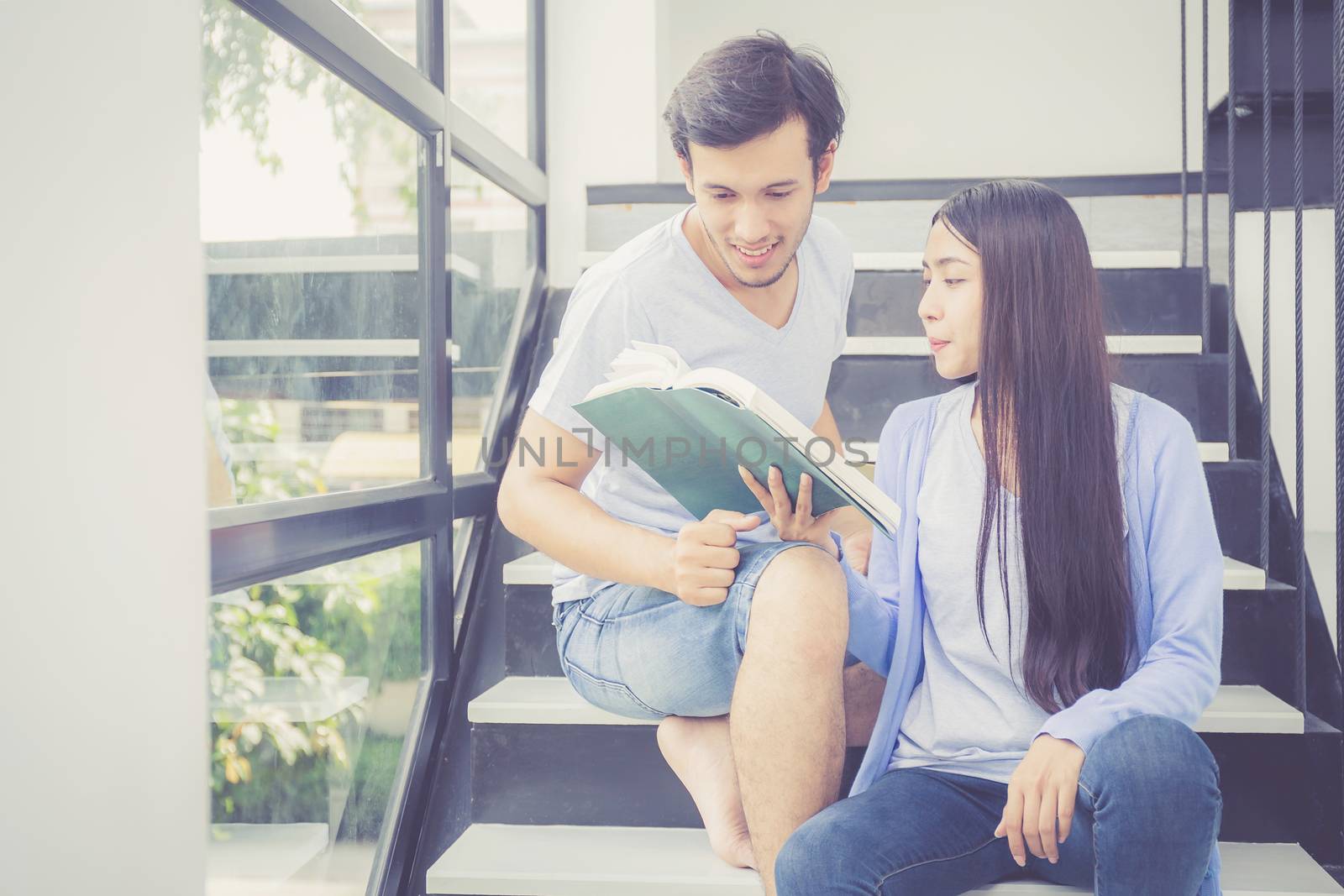 Couple asian handsome man and beautiful woman reading book and s by nnudoo