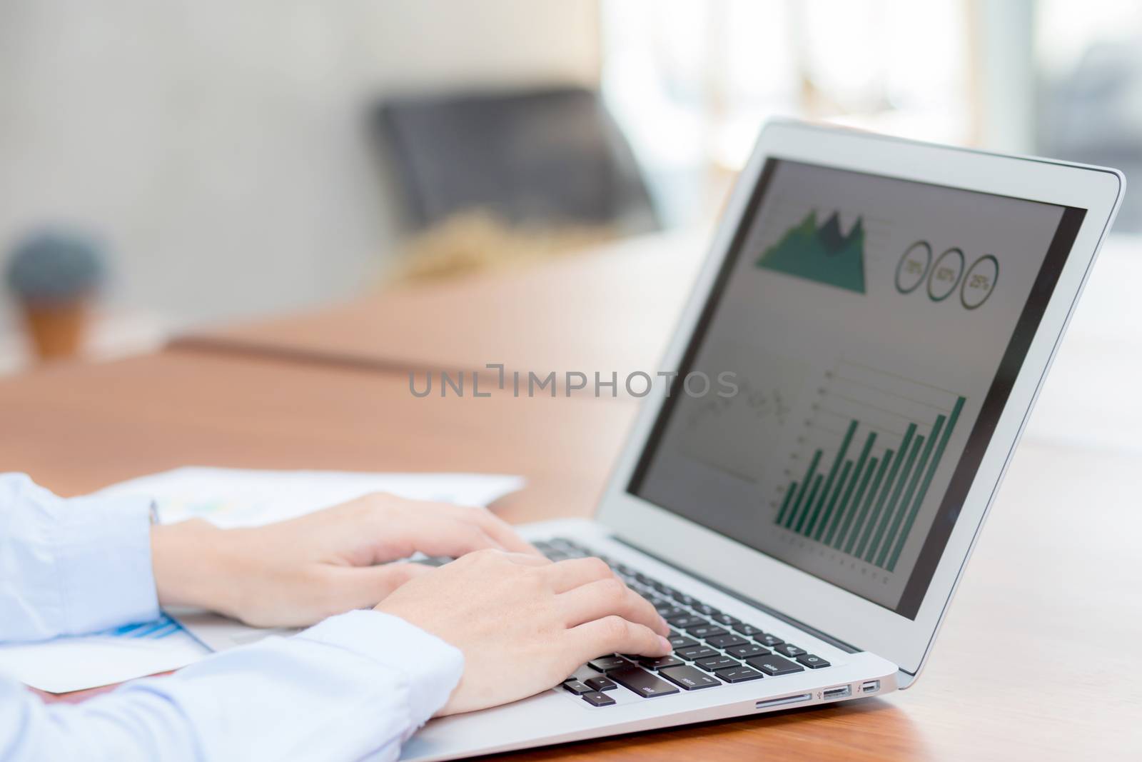 Closeup work with finance analysis and planing data on laptop, typing and paper graph with computer statistic for success, business freelance concept.