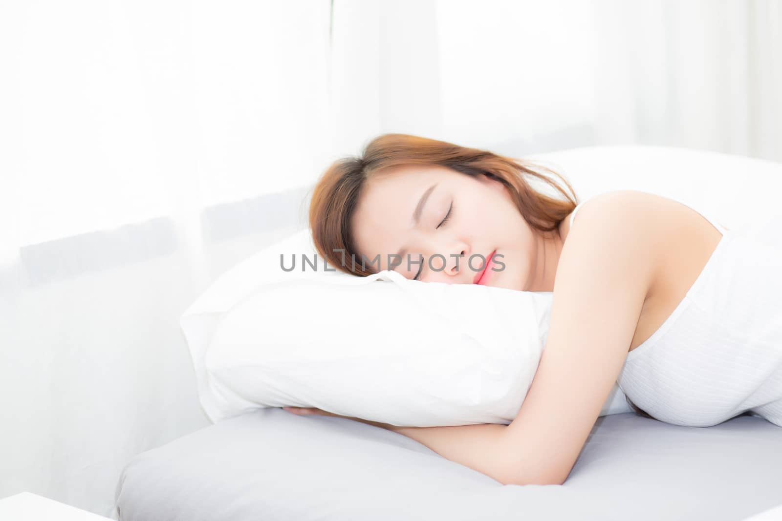 Beautiful asian young woman sleeping lying in bed with head on pillow comfortable and happy. girl with relax for health concept.