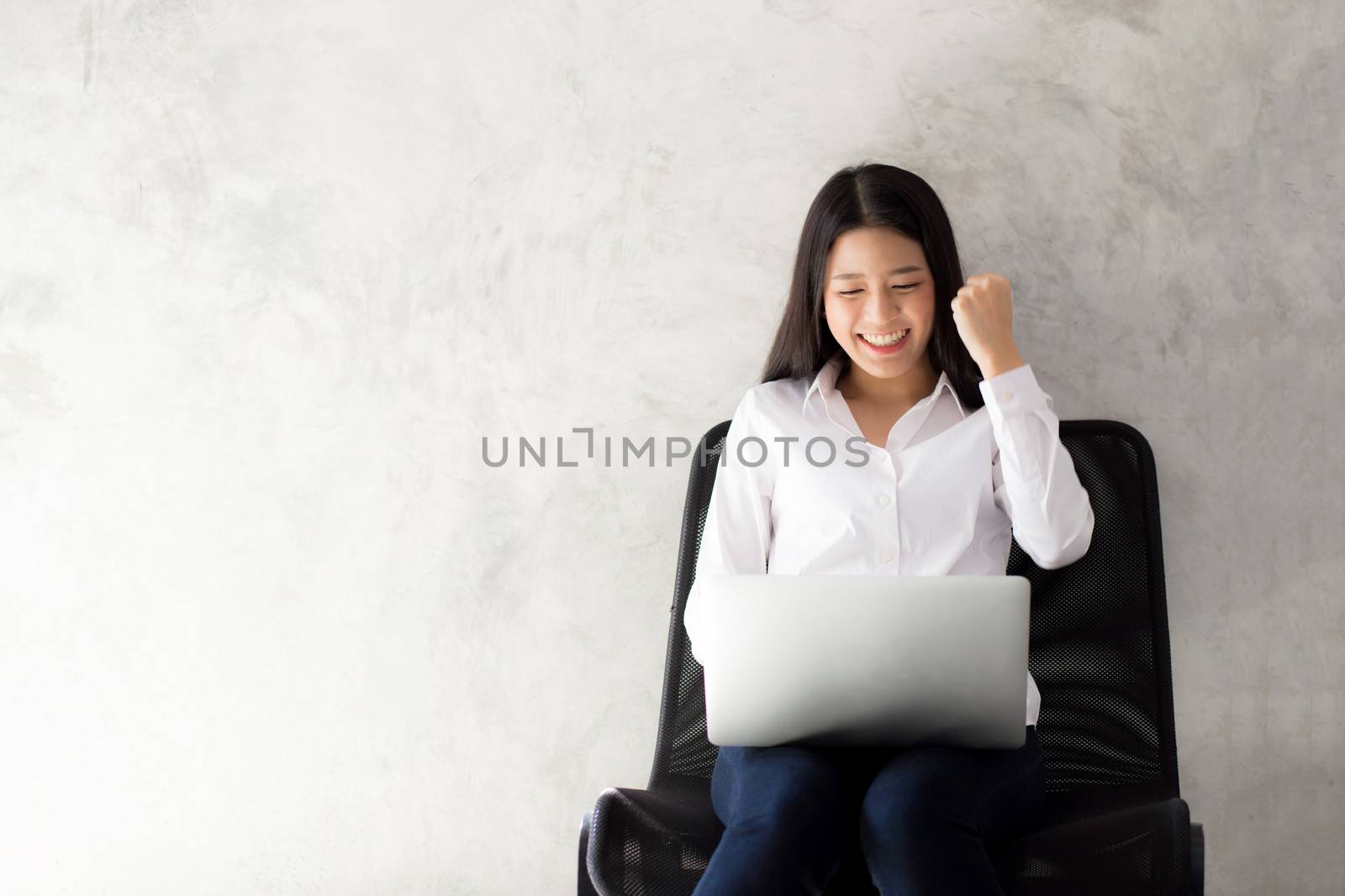 Beautiful asian young woman excited and glad of success with laptop, girl working coffee shop on cement background, career freelance business concept.
