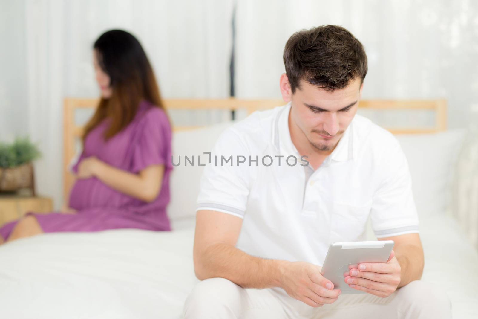 Beautiful asian young woman pregnant and husband with tablet with problem relationship, unhappy and stress, family with abortion concept.