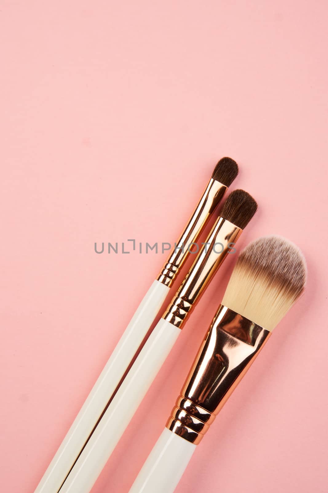 eyeshadow accessories beads makeup brushes collection professional cosmetics on pink background. High quality photo