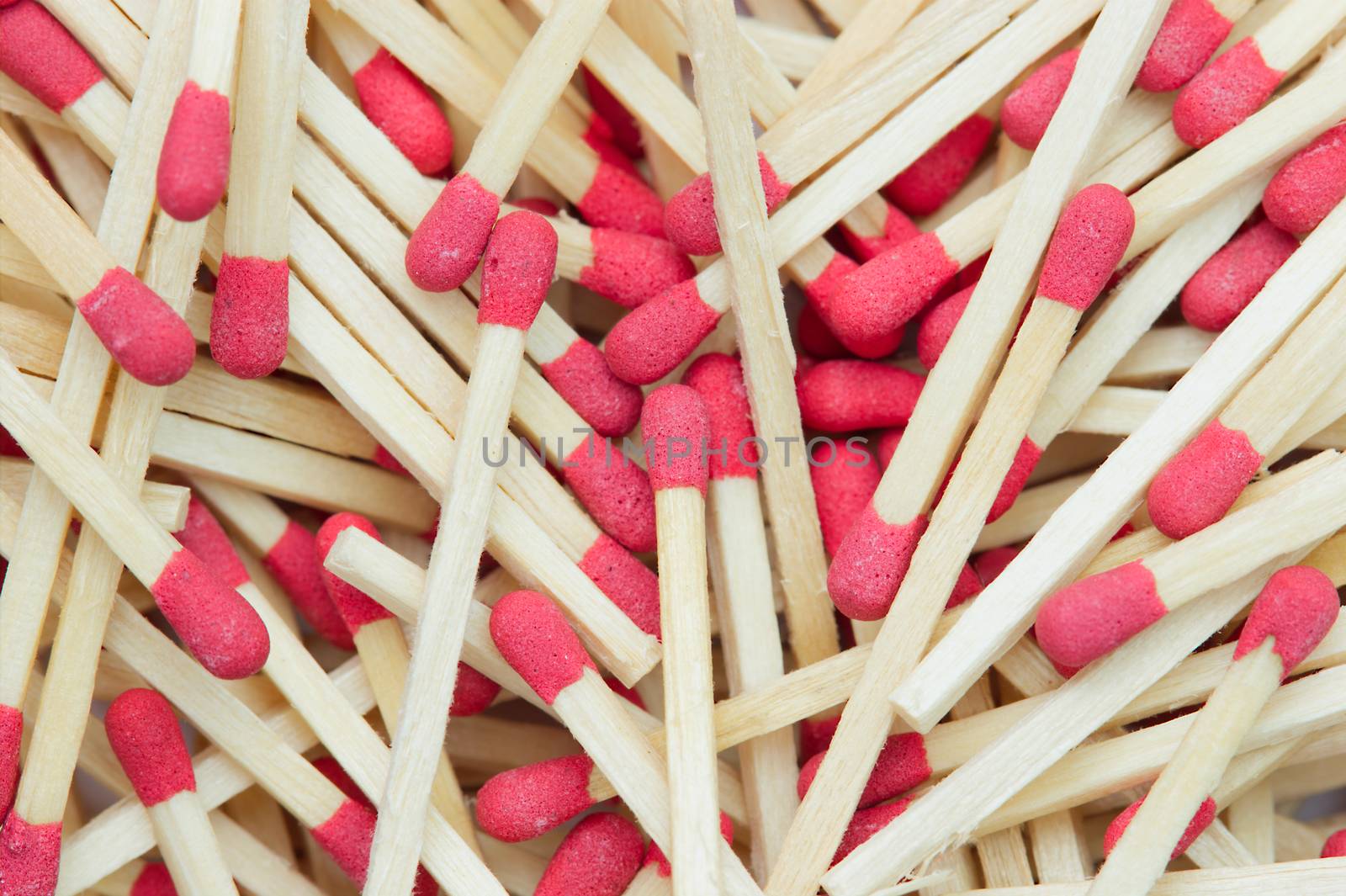 Closeup texture background of many the match stick is stacked in bright light. Top view and copy space for article. The concept of flammable or fire hazard.