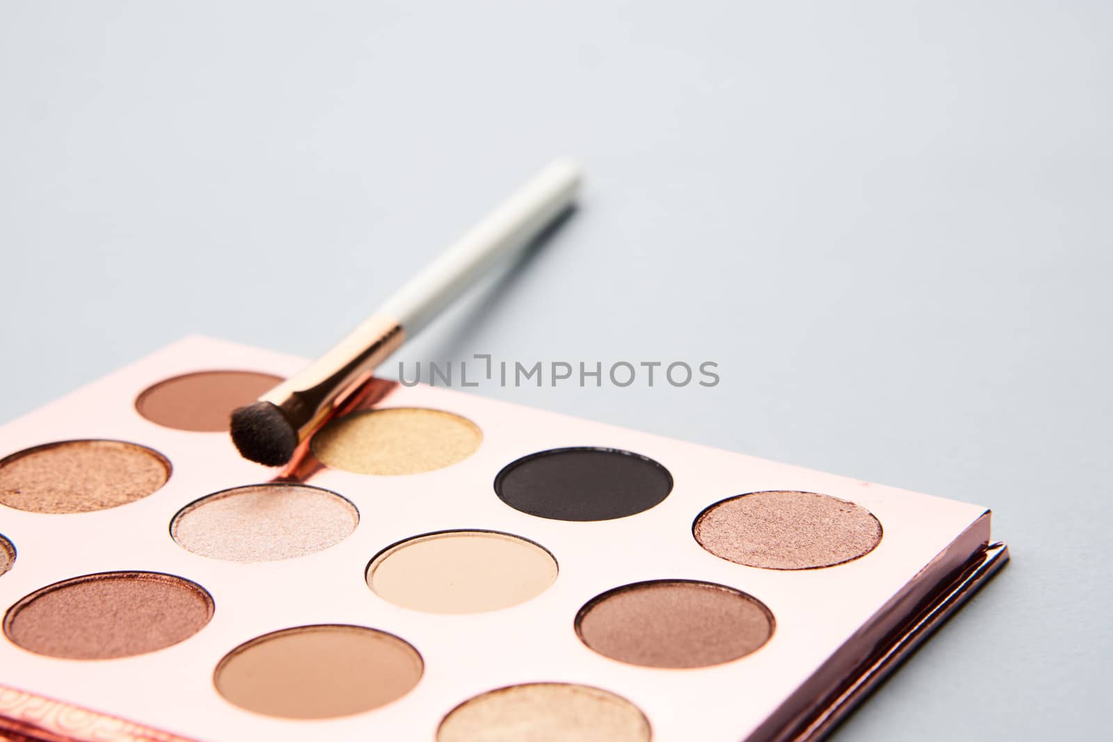 makeup brushes eyeshadow collection professional cosmetics on gray background. High quality photo