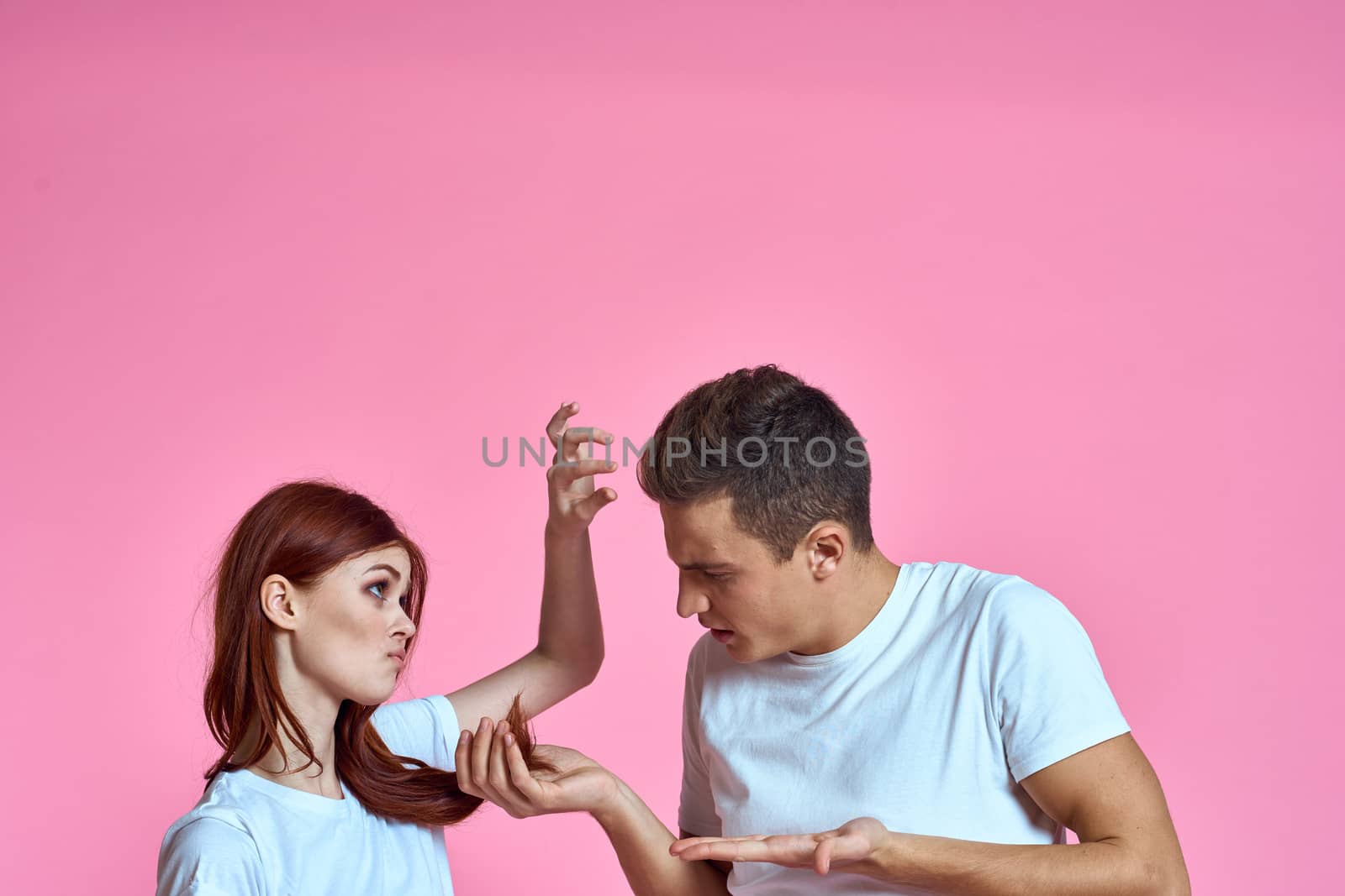 enamored man and woman hugging each other on a pink background cropped with Copy Space family portrait by SHOTPRIME