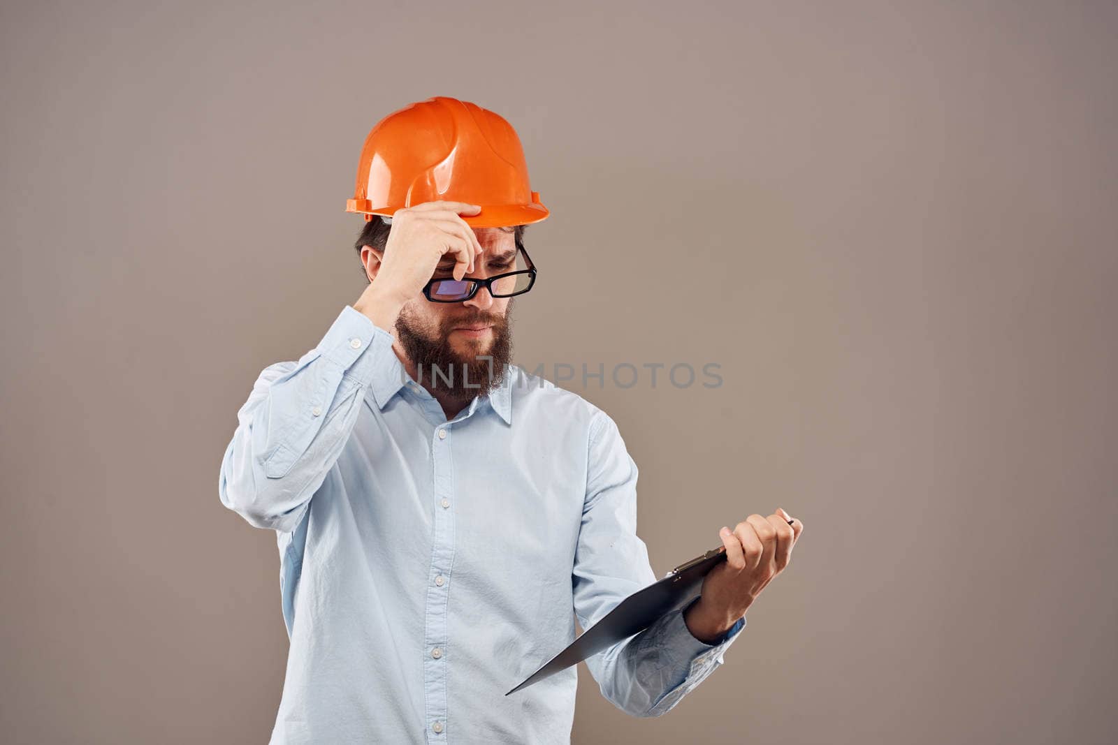 Business man in orange paint documents industry lifestyle beige background. High quality photo