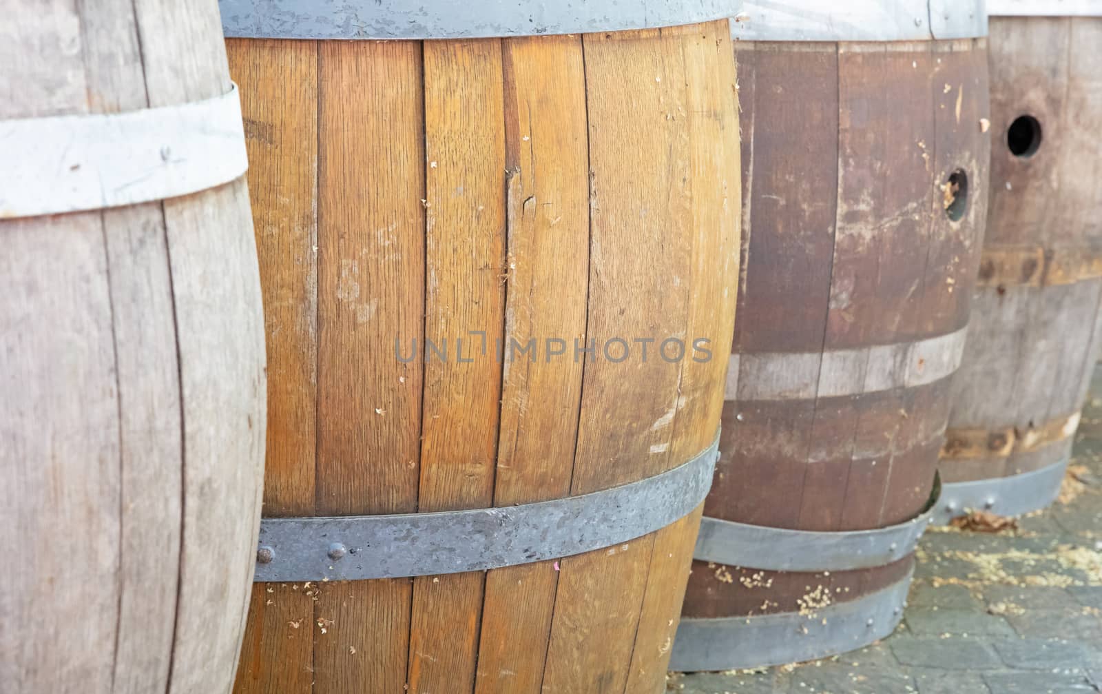 Row of wooden rain barrels, selective focus